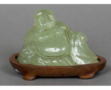 A Chinese carved hardstone model of BuddhaModelled seated, mounted on a carved wooden plinth base.  11 cm wide.    CONDITION 