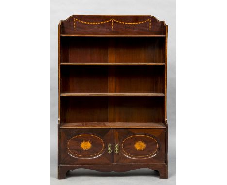 An Edwardian inlaid mahogany bookcaseThe three quarter galleried top inlaid with trailing husks above four shelves over twin 