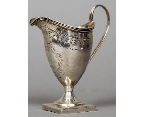 A George III silver cream jug, hallmarked London 1799, maker's mark of (?)B ABOf helmet form with a band of foliate engraving