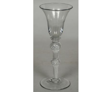 An 18th century air twist wine/gin glass The trumpet bowl with double knop stem and conical foot.  16.5 cm high.    CONDITION