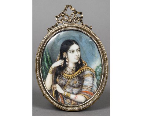 INDIAN SCHOOL (19th/20th century)Portrait of a MaharaniWatercolours probably on ivory, in oval ribbon tied silver frame hallm