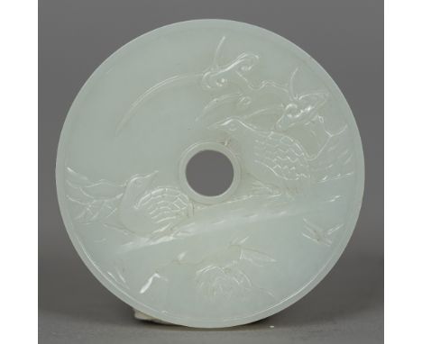 A Chinese carved white jade bi disc Worked with quails. 5.5 cm diameter.   CONDITION REPORTS:  Generally in good condition, e
