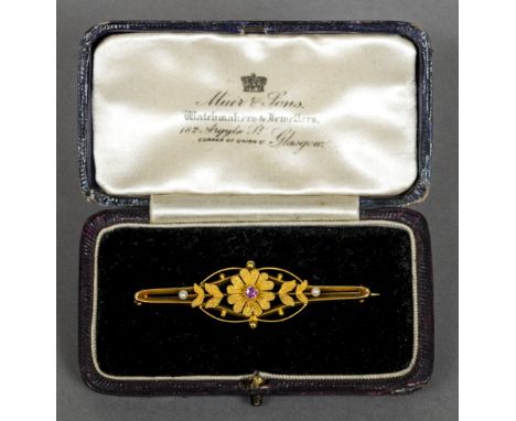 A 15 ct gold pink sapphire and seed pearl set broochOf pierced floral form, bearing Chester hallmarks.  5.5 cm wide.    CONDI