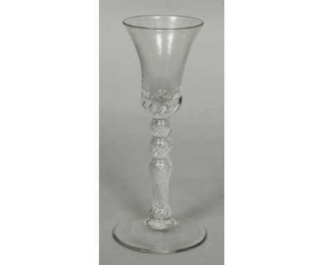 An 18th century air twist wine or gin glassThe trumpet bowl with baluster stem and spreading foot.  16 cm high.    CONDITION 