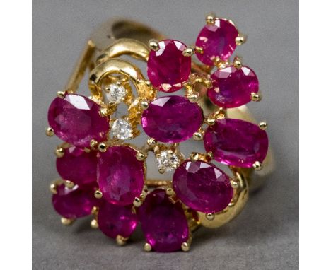A 14 K gold diamond and ruby ringOf cluster form.  2.5 cm high.   CONDITION REPORTS:  Generally in good condition, some gener