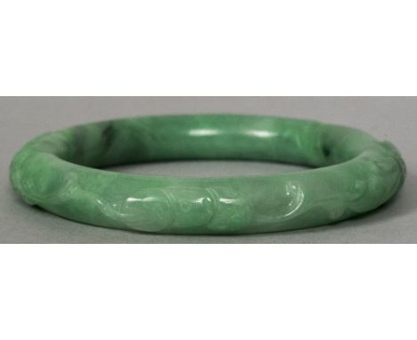 A Chinese carved green jade bangle8 cm diameter.    CONDITION REPORTS:  Generally in good condition, expected wear. Approxima