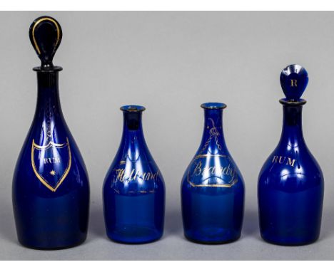 Four 19th century Bristol blue glass spirit bottlesEach heightened with gilt decorations, two for Rum, one Brandy and one Hol