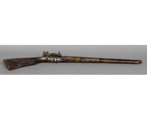 An antique North African mother-of-pearl and metal inlaid flintlock rifle95 cm long.    CONDITION REPORTS:  In need of attent