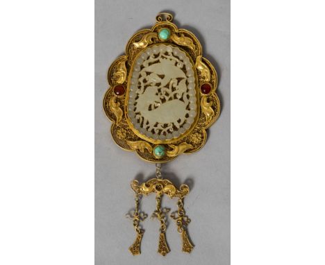 A gilt white metal jade and gem set mounted filigree pendantThe jade panel carved and pierced with animals.  16 cm long overa