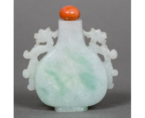 A Chinese jade snuff bottleOf flattened vase form with twin pierced dragon handle and coral cabochon stopper.  5.5 cm high.  