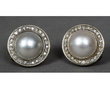 A pair of 14 K gold, diamond and pearl set earringsEach central split pearl enclosed by a row of small diamonds.  Each 2 cm d