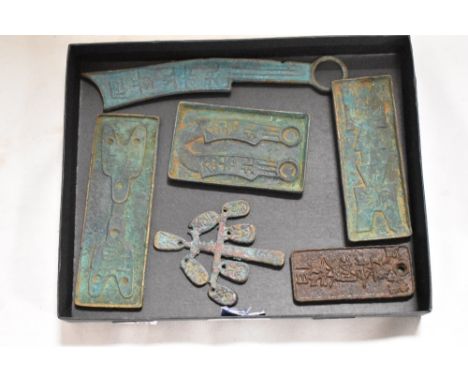 A selection of reproduction cast metal Chinese seal tokens, and plaques including a lucky money tree trinket.