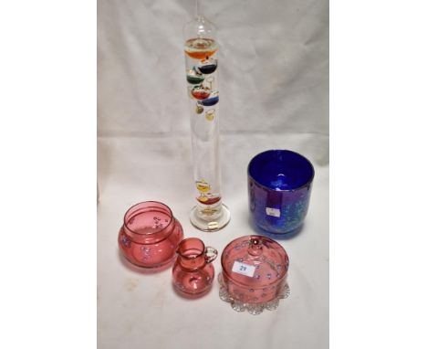 Three pieces of early 20th century cranberry glass with enamel decorated floral designs, a Heron glass planter and a thermome