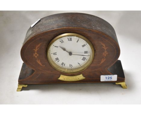 An Edwardian balloon style mantel clock having inlaid mahogany case on brass feet.