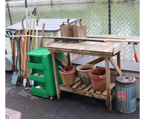 A teak rectangular two-tier potting table, 42” wide x 36” high; a green plastic tool-cabinet; various garden tools, etc. 