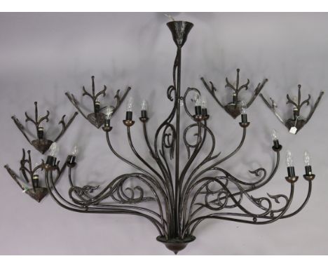 A black wrought-metal twelve-branch chandelier, 49” wide x 45” high; &amp; a matching set of five wall lights, 14” wide.