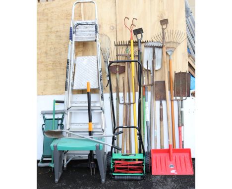 A Powerbase push-along lawnmower; together with two step ladders; &amp; various garden tools.