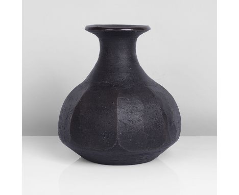 Stoneware, dry black body with a tenmoku glazed interior and rim, cut-sided body, impressed JL and Leach Pottery marks H 13.9