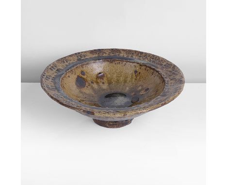 Stoneware, running green ash glaze with iron splashes, the flared rim with repeated impressed markings, impressed WM and Leac