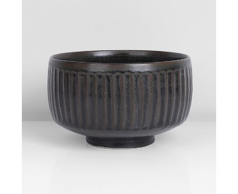 Porcelain, dark tenmoku glaze with contrasting matt and shiny surface over a finely fluted body, impressed DL and Leach Potte