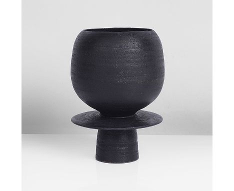 Stoneware, black glaze with incised spirals to the surface beneath the glaze, a short drip running from the rim, impressed HC