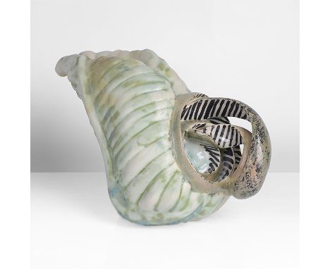 Earthenware, mottled cream and green glazes on a relief cabbage leaf body, with a double looping handle, painted black and wh