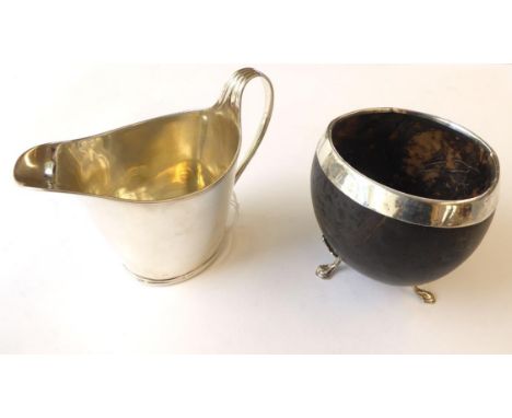 A George III Silver Cream-Jug by John Scofield, London, 1794, helmet shaped and with reeded rim and scroll handle, 11cm high;