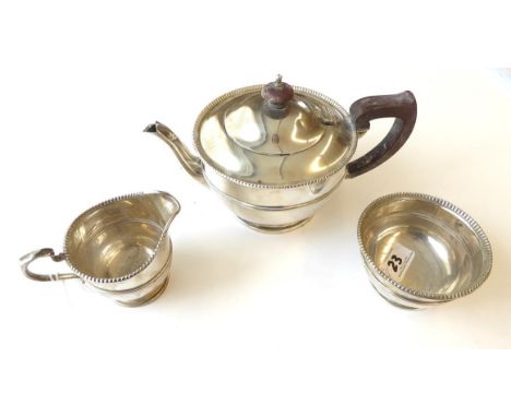 A Three-Piece George V Silver Tea-Service, by Adie Brothers, Birmingham, 1932 and 1935, each piece tapering cylindrical and o