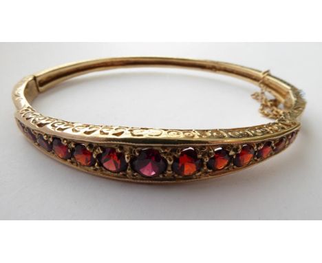A Victorian Garnet Bangle, stamped '9CT' .  Gross weight 17.6 grams. 