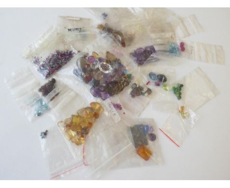 A Quantity of Loose Gemstones, including garnets, rubies, sapphires, peridot, paste, synthetic ruby, emeralds, amethyst, opal