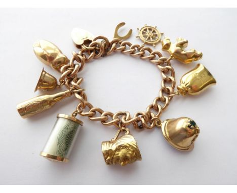 A Charm Bracelet, stamped '9C', hung with ten charms including an owl, a helmet, a wishbone etc, length 19cm .  Gross weight 