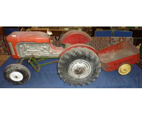 Triang pedal tractor with main plastic body and metal frame, plastic wheels and tinplate mud guards and tractor seat with ass