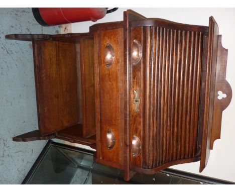 Edwardian light oak roll top desk with raised top, sliding door revealing fitted interior with single drawer above bookcase b