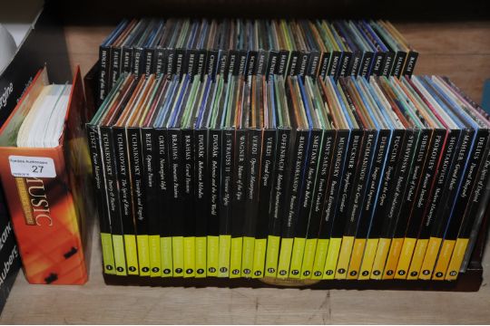 Selection Of Classic Composers Cds And Booklets On Wooden Display Shelves In Unopened Packets