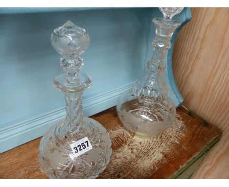 TWO ANTIQUE CUT GLASS DECANTERS AND THREE SILVER MOUNTED BUTTON HOOKS.