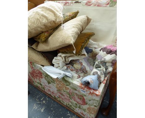A LARGE VICTORIAN UPHOLSTERED OTTTOMAN TOGETHER WITH A LARGE QTY OF LINENS, TEXTILES,ETC