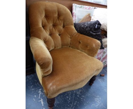 A VICTORIAN BUTTON BACK ARMCHAIR.