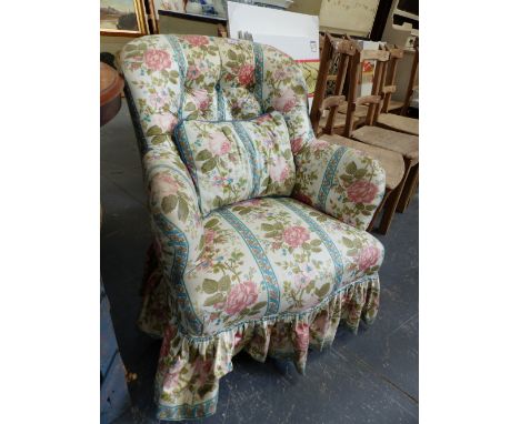A VICTORIAN FLORAL DECORATED BUTTON BACK ARMCHAIR.