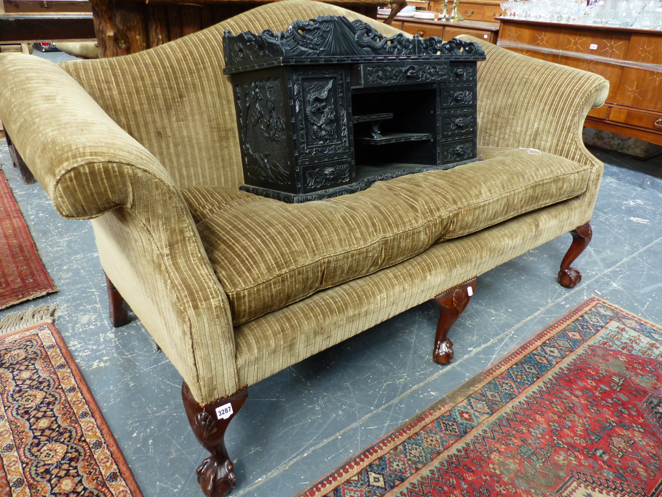 A GOOD QUALITY STYLE CAMEL BACK SETTEE WITH SCROLL ARMS