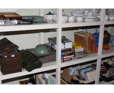 Ammunition box and contents, military helmet, small ledger desk, various games, model vehicles, baby walker, etc.
