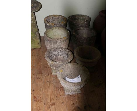 Collection of seven weathered garden planters.