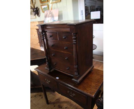 Stained miniature scotch chest of six drawers with turned pillars, 59.5cm by 50cm.