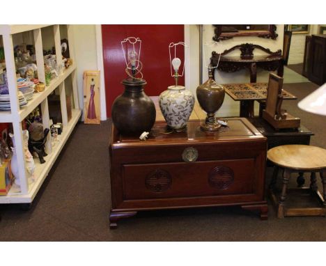 Oriental camphorwood trunk and three table lamps.