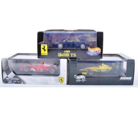 A collection of x3 Mattel made Hot Wheels 1/43 scale boxed diecast model F1 Formula One racing cars and one other comprising;