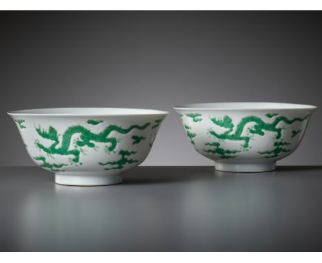 A RARE PAIR OF MING-STYLE GREEN-ENAMELED 'DRAGON' BOWLS, KANGXI PERIODChina, 1662-1722. Each with deep rounded sides supporte