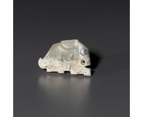 A PALE CELADON JADE 'HARE' PENDANT, LATE SHANG TO WESTERN ZHOU DYNASTYChina, 1100-1000 BC. Depicted crouching with its feet t