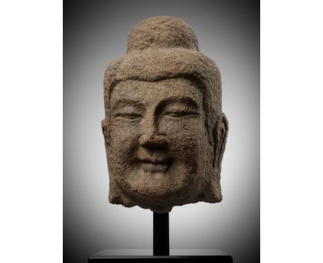 A MONUMENTAL SANDSTONE HEAD OF BUDDHA, NORTHERN WEI DYNASTY, CHINA, 386-534Opinion: The head is carved from buff sandstone th