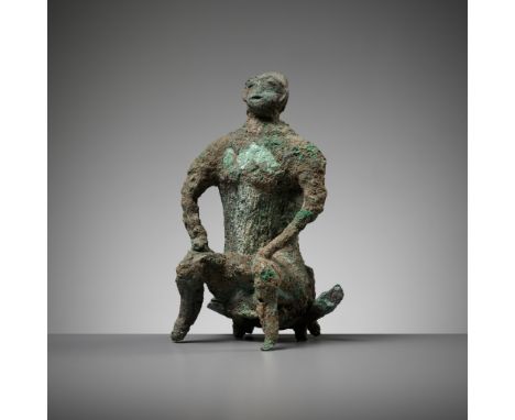 A BRONZE FIGURE OF A SEATED MAN, DONG SON CULTUREVietnam, 500 BC to 300 AD. Modeled as a nude man seated on a folding stool, 