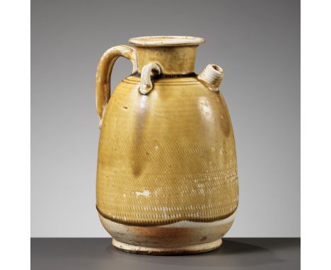 AN AMBER GLAZED 'HATCHED' EWER, TANG DYNASTYChina, 618-906. The ovoid body rising from a short foot to a flaring neck, set wi