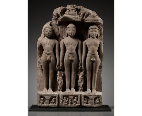 A JAIN SANDSTONE STELE OF THREE JINAS, WESTERN INDIA, RAJASTHAN OR GUJARAT, 10TH-12TH CENTURYFinely carved in high relief wit